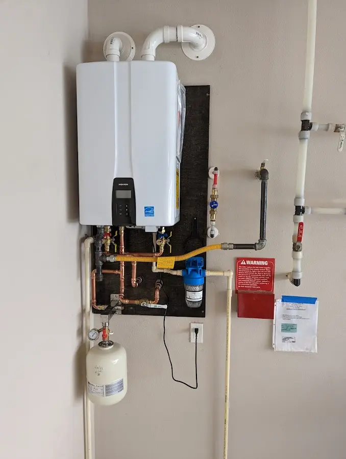 Professional plumber installing copper piping in a Westerlo home